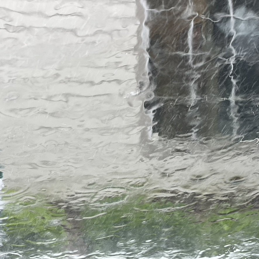 Heavy rain streaming down a window